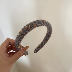 Close-up of thick knitted headband featuring colorful wool texture and plush mohair material