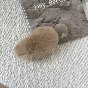 Close-up of soft camel rex rabbit fur hair claw clip on minimalist lifestyle background