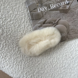 Detail view of ultra-soft cream rex rabbit fur hair claw clip in a cozy home setting