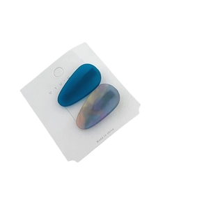 Pair of minimalist acetate teardrop hair clips in navy blue and marbled patterns