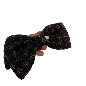 Elegant black tweed bow hair clip with gold thread and metallic button accessory