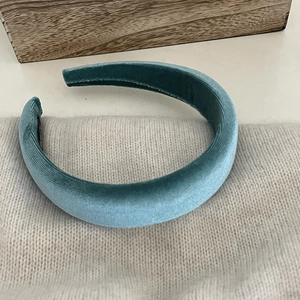 Detail of premium sky blue velvet padded headband with textured vertical ribbing