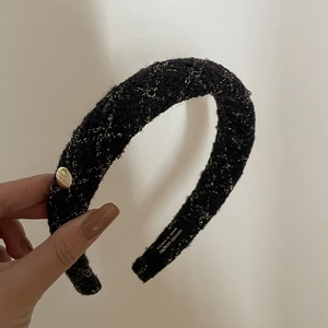 Detailed macro view of handmade French tweed headband with gold thread and metal button