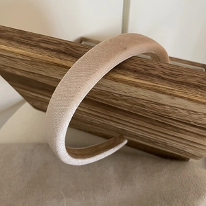 Detail of elegant champagne padded velvet headband with premium non-slip texture