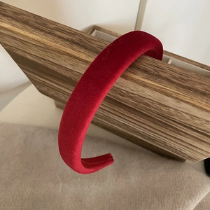 Detail view of thick red velvet headband with a minimalist padded vintage design