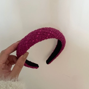 Close-up of rose pink tweed headband with sequins and non-slip inner lining detail
