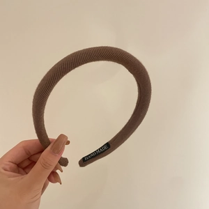 Caramel brown knitted headband for women with handmade label and retro ribbed texture