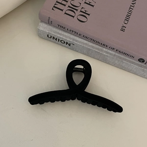 Large black flocked geometric hair claw clip for women featuring elegant crossed curved design