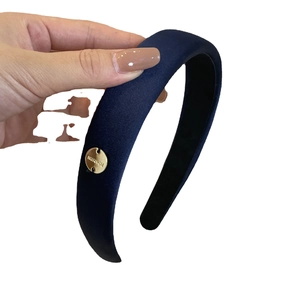 Navy blue satin fabric headband with gold metal tag and thick sponge padding