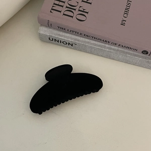 Minimalist black flocked geometric hair claw clip with matte texture for women