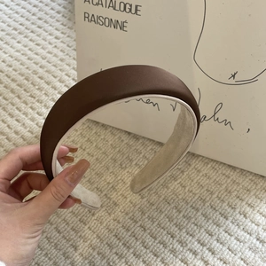 Elegant dark brown padded headband with soft matte silk fabric and velvet non-slip lining