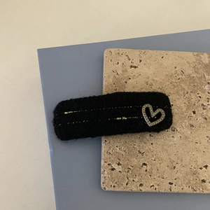 Elegant black knit hair clip with gold thread stripes and a sparkling heart diamond detail