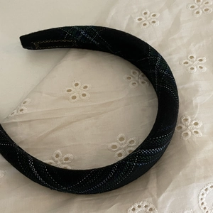 Detail of navy plaid sponge headband with silver metallic threads on lace background