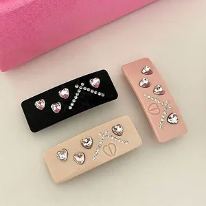 Three-piece acetate hair clip set with sparkling heart rhinestones and CD logo accents