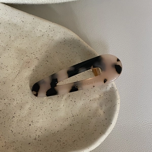 Macro detail of tortoiseshell acetate hair clip with Creation France engraving