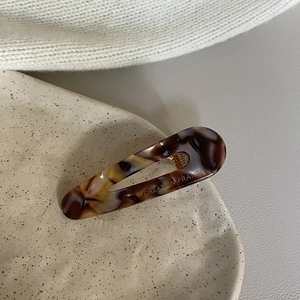 Detail of tortoise shell acetate hair clip with Creation France engraving on tray
