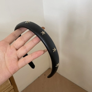 Handmade black leather headband with gold starfish rivets for elegant hair styling