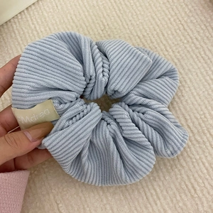 Light blue corduroy oversized scrunchie with Marea fabric label for hair styling