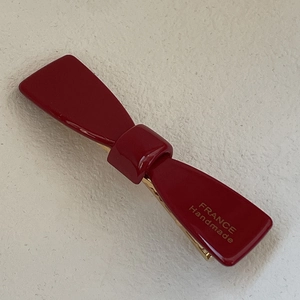 Glossy burgundy bow hair claw with gold France Handmade logo on ivory background