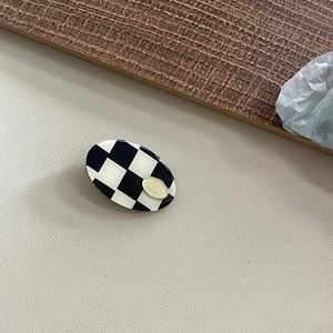 French vintage acetate oval hair clip with black and white checkerboard and gold logo