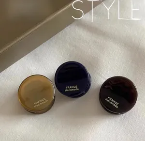 Detailed view of three-piece acetate hair claw set in amber, navy, and brown colors