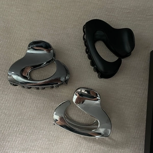 Three minimalist metal hair claws in heart shape with silver and matte black finishes