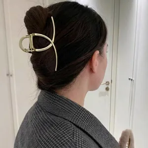 Elegant gold metal large hair claw clip in a minimalist geometric design for thick hair