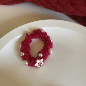 Red plush hair tie with white pearl beads and a flower pendant featuring a Chinese Fu character