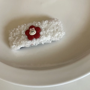 Cute white plush bunny hair clip with red flower accent on ceramic tray for girls