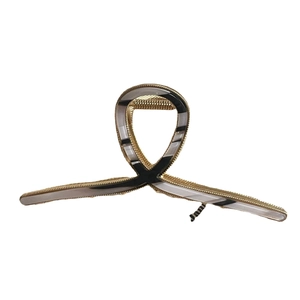 Large golden metal hair claw clip with black and white acetate marble texture