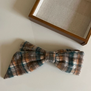 Classic plaid bow hair clip with pumpkin color palette for vintage autumn style hairstyles