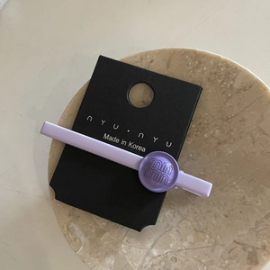 Elegant purple lavender hair clip with embossed lettering in minimalist Korean style