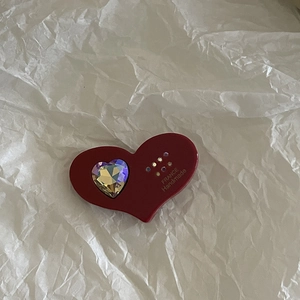 Detail of red heart hair claw clip with crystal inlay and gold handmade lettering