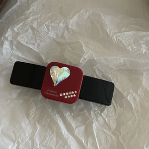 Detail of a burgundy hair clip featuring a sparkling heart crystal and French handmade text