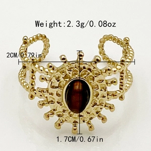 Bague en acier doré avec motif soleil vintage et pierre précieuse marron sertie