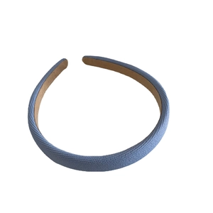 Light blue textured fabric headband with brown non-slip lining for daily hair styling