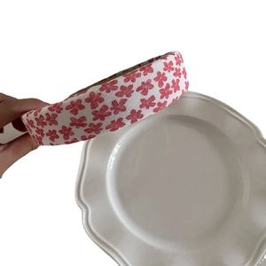 Padded floral headband with red strawberry flower patterns on white fabric texture