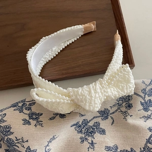 French style milk white pleated headband with elegant pearl trim and a large 3D bow