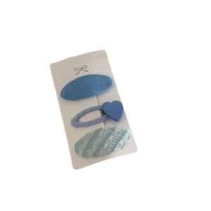 Three-piece set of blue textured hair clips for girls on a white display card