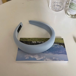 Puffy light blue satin headband with a high top design for a stylish summer look