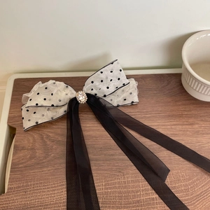 Vintage black polka dot lace bow hair clip with central oval rhinestone and long ribbons