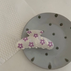 Detail of Korean floral hair claw clip in creamy white with purple flower print