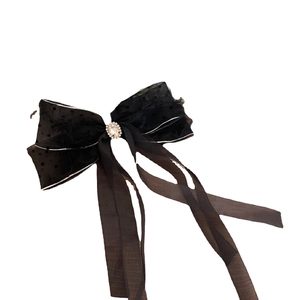 Elegant black polka dot chiffon bow hair clip with crystal detail and long flowing ribbons