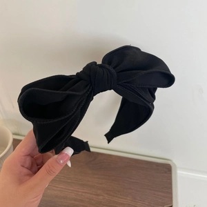 Detail of the soft black chiffon fabric texture on a large French style bow headband
