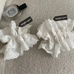 Comparison of single and double layer white lace cotton scrunchies with floral embroidery