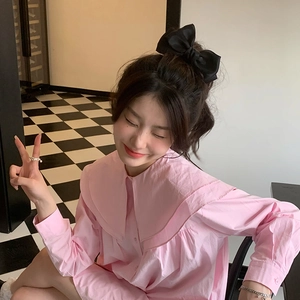 Elegant pink doll collar blouse with a large black satin bow hair clip for a sweet style
