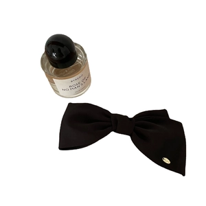 French style satin bow hair clip with a small gold metal logo tag in black