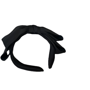 Elegant oversized black satin bow headband for women with a minimalist aesthetic style