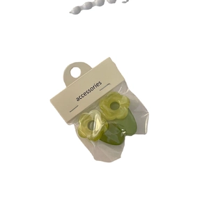 Set of two green jelly flower hair clips with acetate finish on a white background
