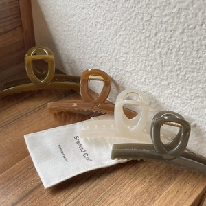 Set of four large glossy acrylic cross hair claws in olive, brown, cream, and grey colors